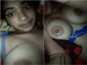 Young woman flaunts her breasts in solo video