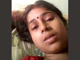 A seductive wife reveals her breasts and stimulates herself with her fingers