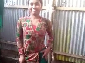 Indian woman bathes outdoors in rural setting