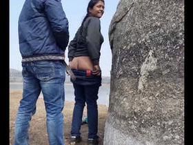 A bold pair discovered engaging in intimate acts by the water's edge