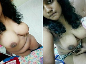 A young woman from India touches her breasts sensually