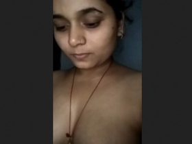 An enticing Indian girl proudly displays her voluptuous bust