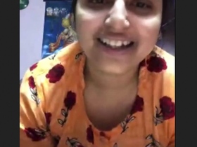 A girl with large breasts proudly displays her full figure