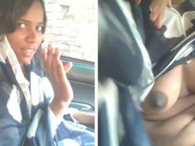 A South Asian woman reveals her breasts and performs oral sex on a man in a vehicle