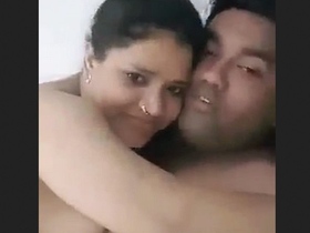 Wife contemplates straddling her husband while he works on his hobby