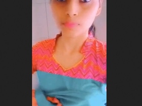 A lovely Indian teenage girl reveals her breasts and vagina