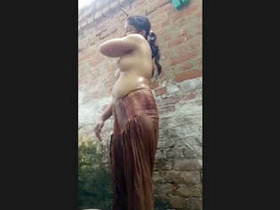 A stunning girl displays her firm, unstained breasts and bathing abilities