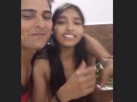 A young couple shares a romantic encounter in a hotel