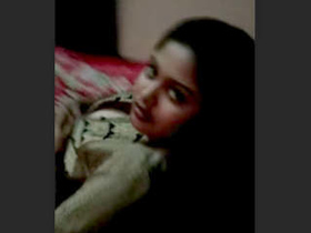 A very attractive Bengali woman moves sensually on the bed and displays herself