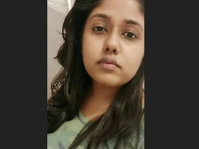 A charming Indian girlfriend takes a selfie while in bed