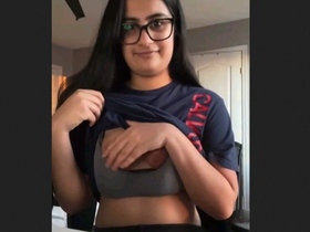 Charming woman flaunts her breasts in a seductive manner