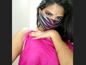 Theera with alluring eyes reveals her breasts and displays aroused demeanor