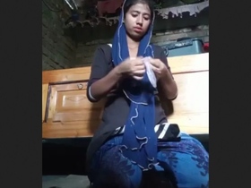 A Bengali girl masturbates with her fingers in a condom