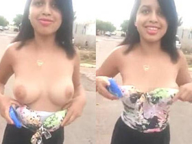 My girlfriend exposes her attractive breasts in a public setting