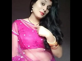 Heena Kumari, a charming housewife, reveals her navel in a sheer saree.